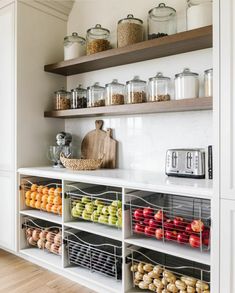 a kitchen with open shelving and lots of food