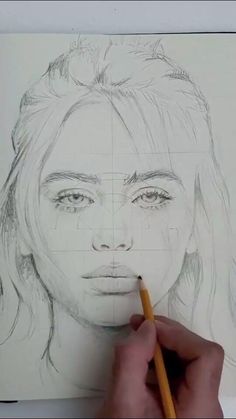 someone is drawing a woman's face with pencils