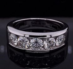 a wedding band with five diamonds on it