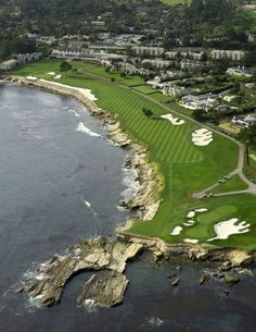 an aerial view of a golf course near the ocean