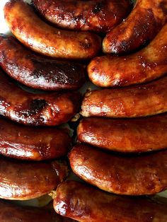 a pile of sausages sitting on top of a white plate next to each other