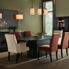 a dining room table with chairs and a bowl on it