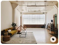 a living room filled with furniture and lots of windows