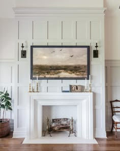 a living room with a fire place and white painted fireplace mantel in the center