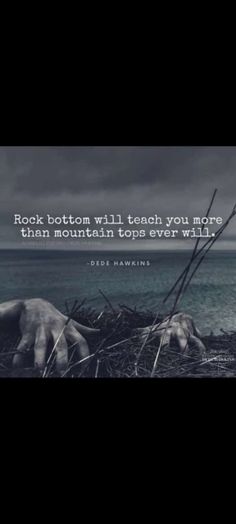 a person laying on the ground next to water with a quote about rock bottom till teach you