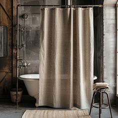 a bathroom with a bathtub, stool and shower curtain