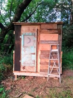 a wooden outhouse with a ladder leaning against it