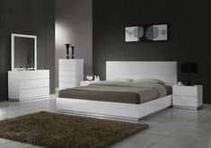 a white bed sitting in a bedroom next to a dresser