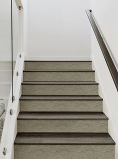 a set of black and white stairs leading up to the second floor