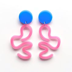 Crafted as part of the Eclectic Curves collection, the Vibrant Pink and Blue Squiggle Earrings feature dynamic acrylic shapes in vivid fluorescent hues, intricately designed to create a fun, eye-catching statement. Inspired by the fluidity and movement found in modern abstract art, these earrings embody a playful yet sophisticated aesthetic, perfect for those seeking to add a bold pop of colour to their style. The Eclectic Curves collection draws inspiration from the organic forms and vibrant energy of contemporary art, celebrating creativity and individuality. Each piece symbolises a commitment to artistic expression and modern design aesthetics. Size: 70mm Materials: Acrylic, Silver Plated Ear Posts Perfect for those embracing their unique artistic spirit and modern sensibilities. Comple Squiggle Earrings, Sophisticated Aesthetic, Acrylic Shapes, Design Aesthetics, Painted Jewelry, Organic Forms, Statement Accessories, Vibrant Energy, Modern Abstract Art