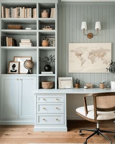 a home office with blue painted walls and white furniture