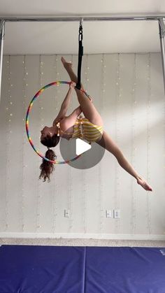 a girl doing aerial acrobatics on a hoop