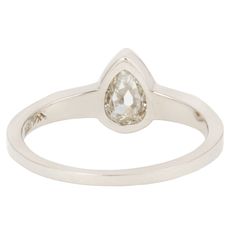 An inverted pear-shaped diamond is the stunning focal point of this one-of-a-kind ring. The bezel setting highlights the unique shape of the stone and draws the eye into its shiny depths. Angled geometric shoulders flank the center setting in Lauren Wolf's signature edgy aesthetic.Stones: .62ct White Inverted Pear-shape DiamondMetal: 18k White GoldMeasurements: Setting length: 13.4mm, Stone length: 4.5mm, Setting width: 8mm, Setting height: 3mm, Band width: 2.1-1.2mmSize 5.75 in stock Shipping a Pear-shaped Single Cut Diamond Ring In Diamond White, Teardrop Platinum Diamond Ring For Formal Occasions, Teardrop Diamond Cut Diamond Ring, Formal Teardrop Platinum Ring, Teardrop Diamond Ring With Single Diamond For Anniversary, Fine Jewelry Teardrop Diamond Ring With Single Cut Diamonds, Teardrop White Gold Rings With Rose Cut Diamonds, Teardrop Rings With Single Cut Diamonds For Anniversary, Teardrop Single Cut Diamond Rings For Anniversary