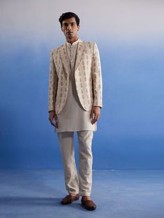 vastramay mens cream leaf printed blazer with kurta pyjama set Beige Long Sleeve Semi-formal Set, Cream Bandhgala For Transitional Season, Cream Fitted Sherwani For Semi-formal Occasions, Semi-formal Fitted Cream Sherwani, Beige Long Sleeve Bandhgala For Diwali, Transitional Beige Fitted Nehru Jacket, Semi-formal Notch Lapel Bandhgala For Festive Occasions, Semi-formal Festive Bandhgala With Notch Lapel, Beige Nehru Jacket For Semi-formal Occasions