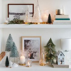 the shelves are decorated with christmas trees, candles and other holiday decorating items on them