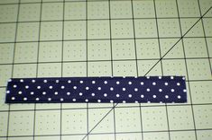 a piece of fabric with white polka dots on it