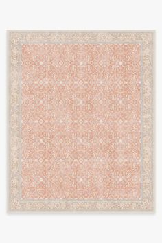 an orange and beige area rug on a white surface with a pattern in the middle