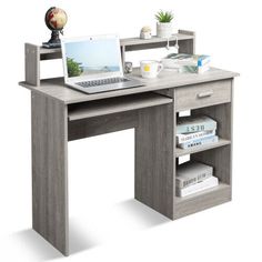 a laptop computer sitting on top of a wooden desk next to a book shelf with books