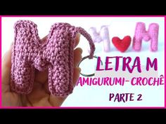 a crocheted keychain with the letter m on it