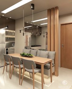 a dining room table with grey chairs next to a refrigerator