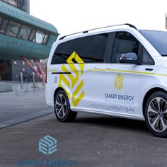 the smart energy van is parked on the side of the road in front of a building