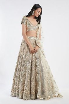 Beige-gold lehenga with all-over leather mirror, resham and badla work. Comes with plunging neck blouse and scallop dupatta.
Component: 3
Embroidered
Neckline: V Neck
Sleeve Length: Half
Fabric: Blouse: Raw silk; Lehenga and Dupatta: Net
Color: Beige, Gold
Tassel tie-up back
Plunging neck
Scallop dupatta - Aza Fashions Abhinav Mishra, Gold Lehenga, Lehenga Dupatta, Raw Silk Lehenga, Golden Mirror, Beige Blouse, Indian Woman, Silk Lehenga, Embroidered Neckline