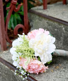 a bridal bouquet sitting on some steps