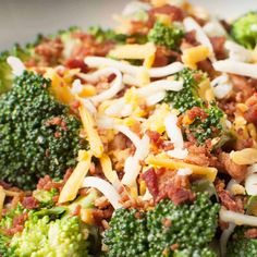 broccoli with cheese and other toppings in a white bowl on a table