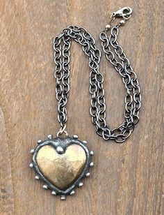 Gorgeous gold brass soldered heart necklace....an amazing hand soldered pendant boasting a puffed gold heart and embellished with silver drops. Gold filled jump rings and beads, silver clasp, and black metal chain. 18 inches long. Pendant is 1.33 x 1.25 inches. Unique Valentine's Day gift or a fantastic statement piece for yourself! This pendant is one of a kind, unmatched! Silver Heart-shaped Brass Necklace, Gold Necklace With Heart Pendant, Metal Heart Pendant Necklace With Soldered Details, Heart-shaped Metal Necklace With Soldered Details, Bronze Heart-shaped Brass Necklaces, Bronze Heart-shaped Brass Necklace, Black Metal Necklace, Schmuck Gold, Gold Schmuck