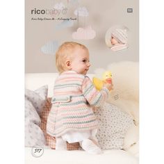 a baby sitting on a bed holding a rubber duck