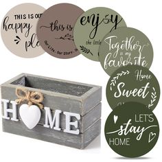 some stickers that are on top of a wooden box with the words home in it