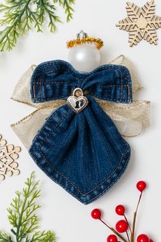 an ornament made out of jeans with a bow on it and decorations around