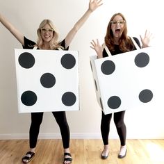 two women in black and white polka dot boxes with their hands up to the side