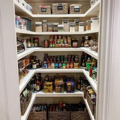 an organized pantry with lots of food in baskets on the bottom shelf and shelves full of spices