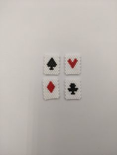 four pieces of beaded art depicting playing cards