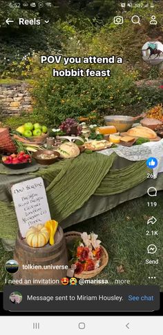 an image of a table full of food on the grass with a sign that says pov you attend a hobbit feast