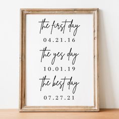 the first day sign is displayed in front of a wooden frame on top of a shelf