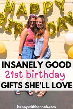 two girls standing in front of a happy birthday sign