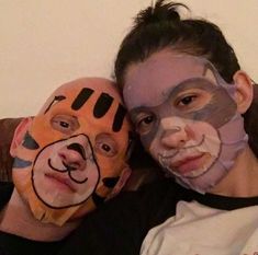 two people with face paint on their faces