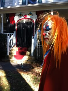 a scary clown is standing in front of a house