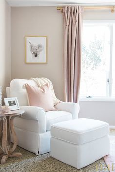 a white chair and ottoman in front of a window