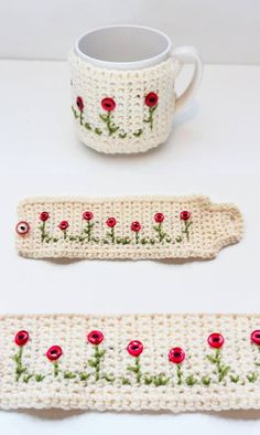 two crocheted mug holders with red flowers on them, one is holding a coffee cup