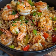 a bowl filled with rice and shrimp on top of a table