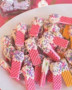 a plate full of waffles and ice cream on a table with candy in the background