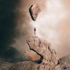 a person standing on top of a large rock