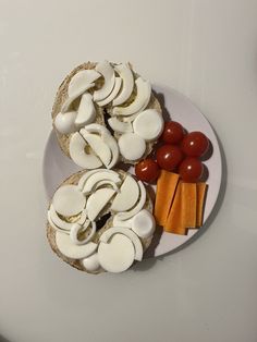 an open face sandwich with mushrooms, carrots and tomatoes on a white platter