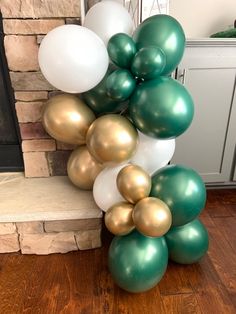 some white and green balloons are on the ground