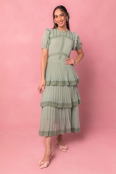 Expertly crafted with a high neckline and flattering waistline, the Jade Dress exudes elegance and sophistication. The ruffle detailing adds a touch of femininity, while the stunning shade of green makes a statement. Complete with pleats, this dress is a must-have for any special occasion. Modest Green Dress, Boho Green Dress, Boho Formal Dress, Garden Party Formal, Green Dress Formal, Spring Pics, Boho Formal, Women Attire, Midi Gown