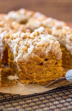 a close up of a piece of cake on a cooling rack with a fork next to it