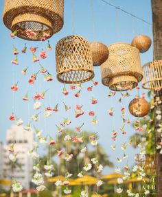 several hanging bird cages with flowers on them